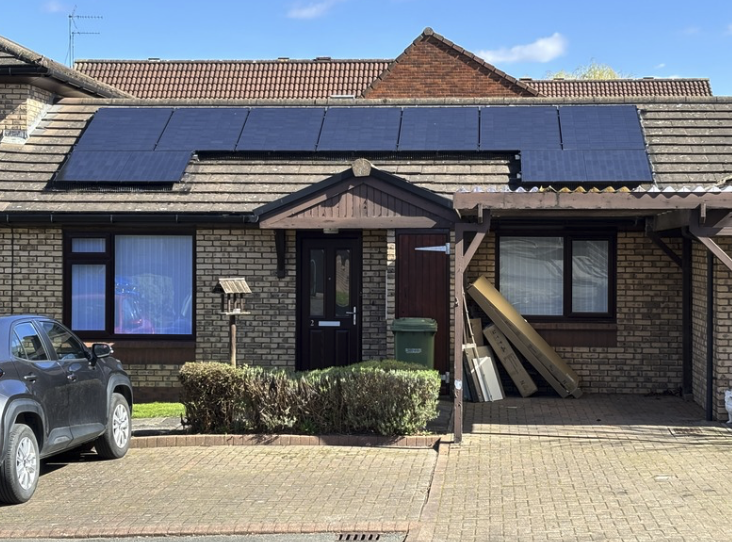 Solar panels installed across the roof of a family home